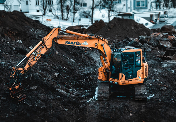 excavator-digging-up-dirt-in-rural-area